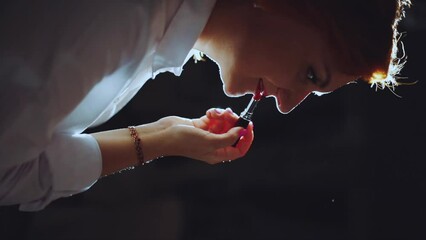 A girl with red hair paints her lips with red lipstick, vertical shooting - Powered by Adobe