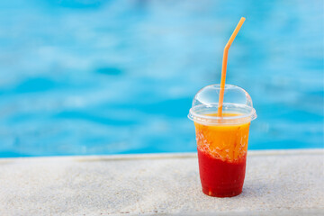 fresh mango with strawberry juice or smoothie near the pool