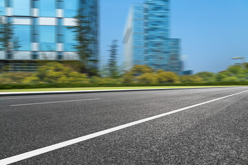 city empty traffic road with cityscape in background.