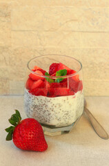 Chia seed pudding with strawberry topping, in a glass