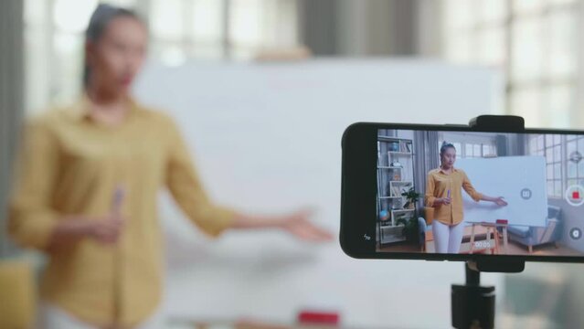Close Up Of Smartphone Camera Recording Asian Female Teacher With Marker Pen Teaching English At Home
