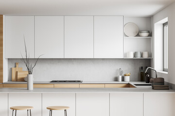 Light kitchen interior with island and seats, shelves and decoration, window