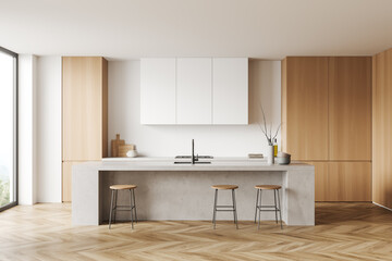 Light kitchen interior with island and seats, shelves and kitchenware, window