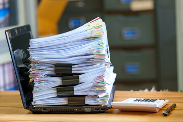 File in database stack of document pace on laptop on the desktop - obrazy, fototapety, plakaty