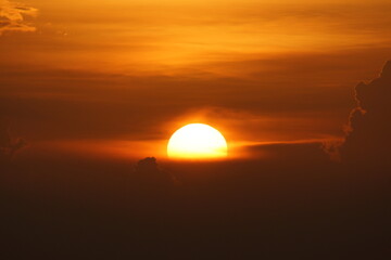 Bright Orange Sun rising on the horizon