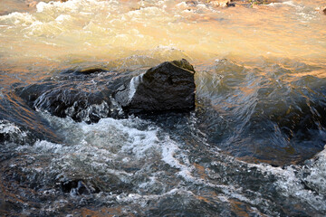 Stone and a seething stream of water