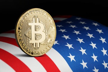 Physical Coin bitcoin with golden piece on USA flag.  Bitcoin mining concept.