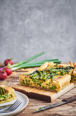 Vegetarian quiche pie with asparagus. Fresh homemade asparagus quiche pie served on rustic wooden table.