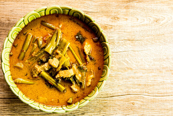 Morning glory with coconut milk  curry or Kang Ta Pho in bowl, Thai famous food.