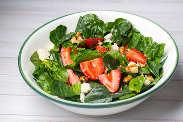 Healthy diet salad; Strawberry Spinach Salad with Avocado.