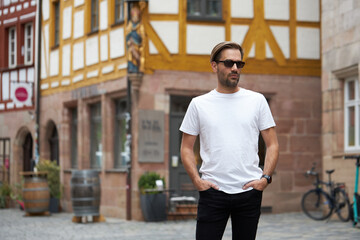 White blank t-shirt on a hipster handsome male model with space for your logo or design in casual...