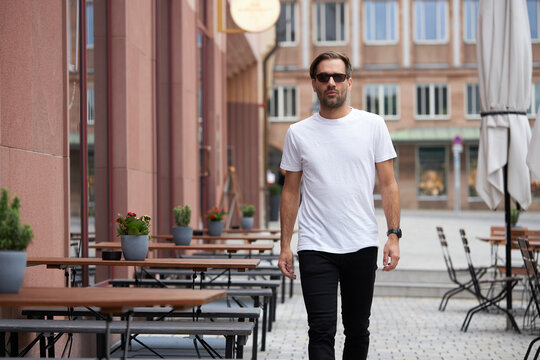 White blank t-shirt on a hipster handsome male model with space for your logo or design in casual urban style