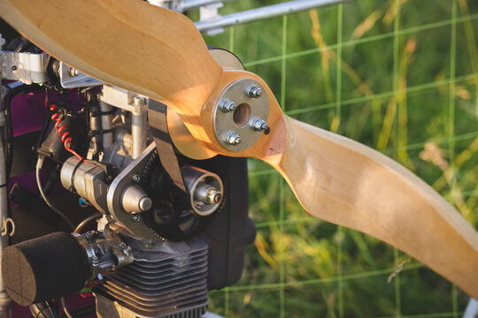 A closeup of a paramotor with a wooden propeller for individual paralet flights. Extreme sports. Selective focus