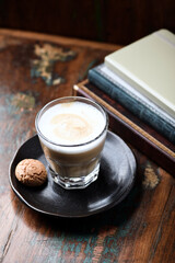 Coffee with milk on rustic wooden background. Soft focus.
