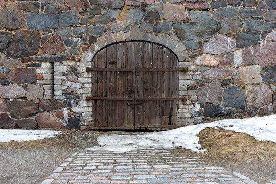 old wooden door in brickstone wall