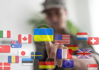 Hand pushing on a touch screen interface, choosing Ukraine. flags of the world