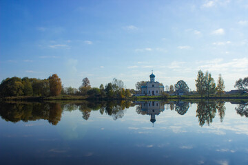 Fototapeta premium reflection of trees in the lake, orthodox church 