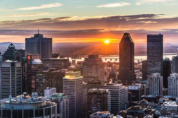 Sunrise over the skyline of Montreal, watched from the Kondiaronk Belvedere in Mont Royal Park.