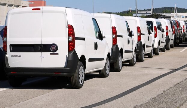 Monfalcone, Italy. May 10, 2021. Backs of brand new Dobl&ograve;, panel van of Fiat automaker, in a row outside the dealership.