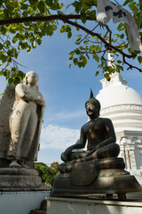 Buddha statues with white stupa and sacred bo tree
