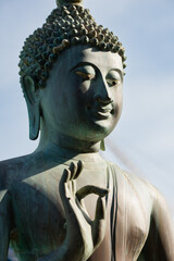 Closeup of bronze Buddha statue, Gangaramaya temple, Sri Lanka