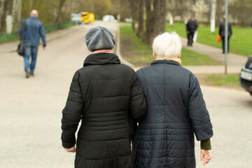 Pensioners in Russia. Women walk down the street. Grandmothers walk down the road.