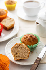 Homemade muffin with colorful paper cups, in a plate served with cup of tea
