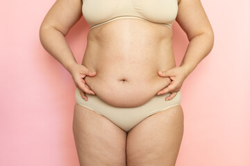 Measure woman sagging belly closeup, folds on stomach, loose skin and cellulite, obesity. Naked...