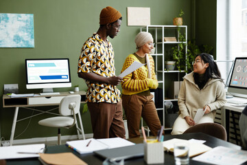 Portrait of creative young team working in office all wearing trend fashion styles
