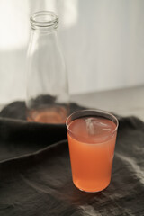 Guava drink in tumbler glass on linen cloth