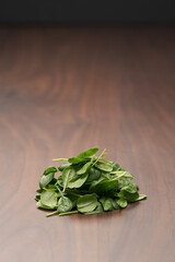 Fresh spinach leaves on walnut wood table
