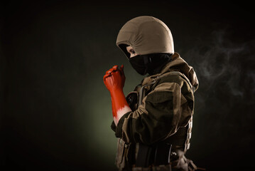 a girl soldier with bloodied hands wearing a helmet and a bulletproof vest