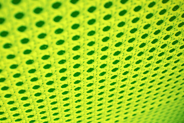 Neon lime colored abstract pattern with holes and lines. Digital and music textures and backdrops
