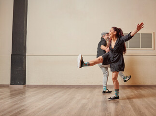 Lindy Hop teacher couple in a ballroom