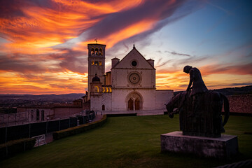 Colorful sunset over the Basilica of San Francesco in the city of Assisi - Italy - 500694245