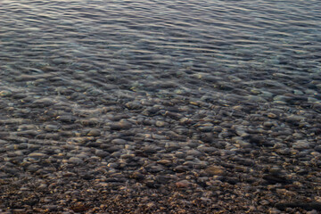 Sea ripple or shiny pebble reflection at Antalya beach, Turkey