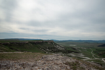 Summer hiking in the mountains. Top view of the green meadows.