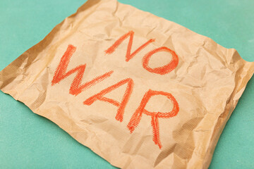 A call for peace and an end to the war on the craft paper. Close-up. No war. Stop war