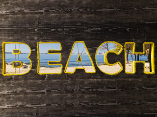 Fototapeta premium Wooden signboard whit a notice beach on the beach