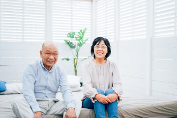 Obraz premium Elderly couple relaxing in their bedroom