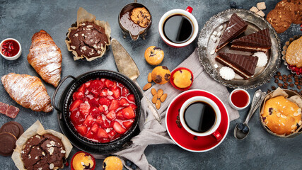 Dessert table with all kinds of cakes and snacks.