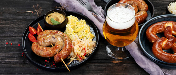 Grilled German sausages on wooden background.