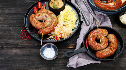 Grilled German sausages on wooden background.
