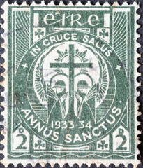 Ireland - circa 1933: a postage stamp from Ireland, showing a cross with believers on their knees...