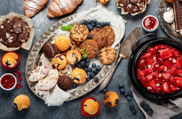 Dessert table with all kinds of cakes and snacks.