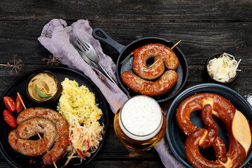 Grilled German sausages on wooden background.