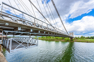 El Pont Penjant de Amposta located in the Ebro delta, Tarragona province, Catalonia Spain, is a suspension bridge inaugurated in 1920. It was inspired by the Brooklyn bridge. - obrazy, fototapety, plakaty