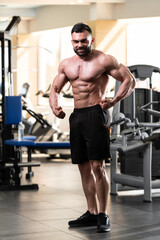 Obraz na płótnie Canvas Muscular Man Flexing Muscles