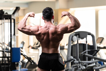 Fototapeta na wymiar Bodybuilder Performing Back Double Biceps Pose