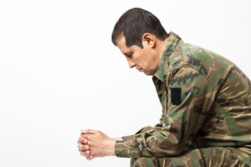 Shot of a soldier sitting on a bench and sadness with white background